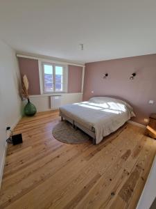 a bedroom with a bed and a wooden floor at Le nid de Raphaël rooftop in Le Puy en Velay