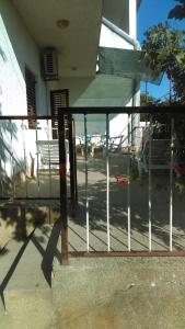 a metal railing on a porch with a table at Peaceful House in Tribunj in Tribunj +1 photo