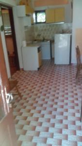 a kitchen with white appliances and a checkered floor at Peaceful House in Tribunj in Tribunj