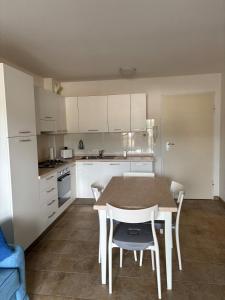 a kitchen with a table and chairs in it at T2 Le Clos des Oliviers in LʼÎle-Rousse