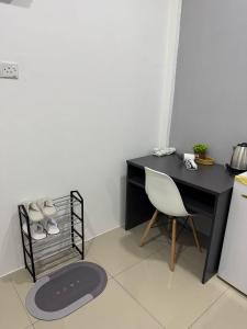 a desk and a chair in a room at Modern & Cozy Home Stay in Kampar +16 photos