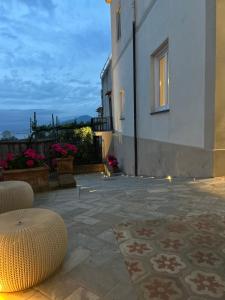 a patio with two chairs and a building at L'antica Pigna Chateau in Vico Equense