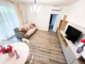 a living room with a couch and a table at Golden Lake Escape in Bucharest