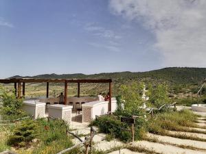 a group of people sitting around a table in a field at 1001-Nights Palace in Nebeur +115 photos