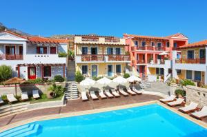 a villa with a swimming pool and some buildings at Sirena Residence & Spa in Marathokampos