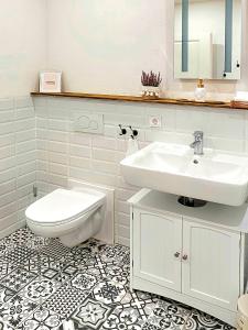 a white bathroom with a sink and a toilet at Apartment Südwind - Beautiful premium apartment with 2 bedrooms near Rhine Falls & Zurich Airport in Klettgau in Klettgau +14 photos