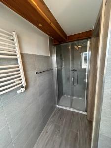 a shower with a glass door in a bathroom at BALTIC VIBES - pokoje gościnne in Kołobrzeg +38 photos