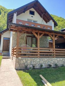 a house with a wooden roof and a porch at Jovan in Šipovo