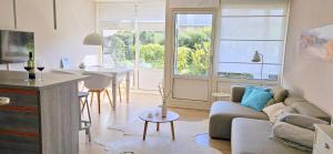 a living room with a couch and a table at Strandnahes Ferienhaus mit Garten hundefreundlich MeerZeit Ameland in Buren
