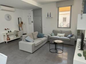 a living room with two couches and a table at Casa Cala del Mar in Cala del Moral