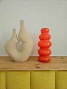 three vases sitting on top of a wooden table at Lovely Sparkly Apartment in Krakow +14 photos