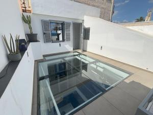 a glass house on the roof of a building at Casa Cala del Mar in Cala del Moral