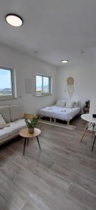 a living room with two beds and a couch at כתר החרמון in Qiryat Shemona