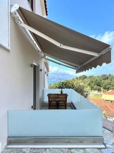 a view from the balcony of a house with awning at Samos Endless Blue 2 in Samos +49 photos