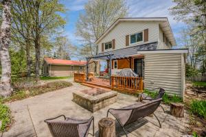 a backyard with chairs and a house at Beeshore Lakehouse Waterfront Bliss & Comfort in Lions Head