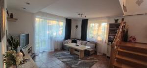 a living room with a couch and a table at Urocze Apartamenty in Cięcina