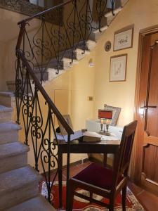 an office with a desk and a chair next to a staircase at Le vecchie poste di Benedetta in Castiglione del Lago