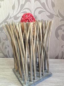 a vase filled with sticks with a red sucker at Hotel Chaplin in Blankenberge