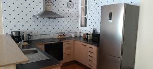 a kitchen with a refrigerator and a sink at Villa Ca Na Llum in Trebeluger
