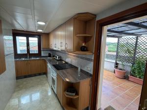 a kitchen with wooden cabinets and a counter top at Vila Mont Rebei in Tolva