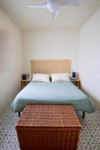 a bedroom with a bed with a blue mattress and a table at Casa Leone in Carratraca