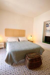 a bedroom with a large bed with a ottoman in it at Casa Leone in Carratraca