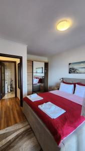 a large bedroom with a large bed with red sheets at Apartment Ulcinj in Ulcinj