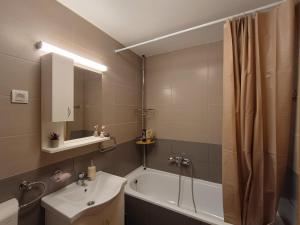 a bathroom with a tub and a sink and a shower at MV Dreams, free parking in Novi Sad +16 photos