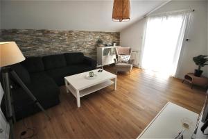 a living room with a couch and a table at Apartment Castelmuschio in Omišalj