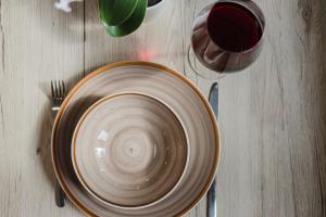 a bowl on a table with a cup and a fork at Das InnSight Appartementhaus - Appartements mit Küchen für Lang und Kurzzeitaufenthalte in Passau