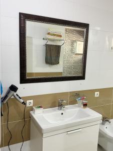 a bathroom with a sink and a mirror at Prishtina House- Prishtina - Germia in Prishtinë +15 photos