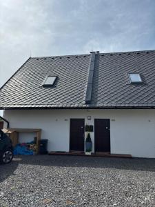 a white house with two doors and a roof at Králíkárna in Králíky