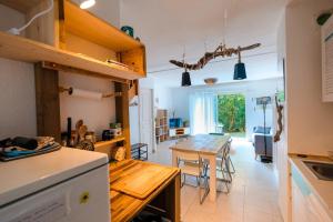 a kitchen with a table and a dining room at Villa ALOHA pool-beach 500m in Santa-Maria-Poggio