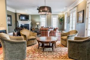 a living room with chairs and a table at 1 Mile to Omni Homestead w/ 5 suites + Gameroom in Hot Springs