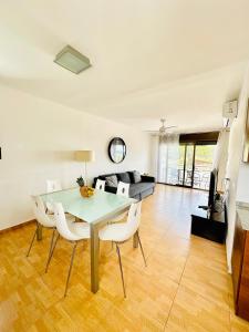 a living room with a table and chairs and a couch at Apartamento en primera línea de mar in Hospitalet de l'Infant