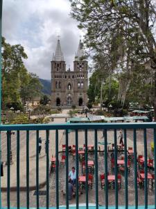 a building with tables and chairs in front of it at El Balcón de Emma in Jardin +26 photos