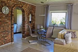 a living room with a table and a brick wall at Ferienwohnung Pasch-Wittke in Geldern