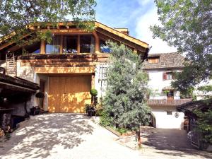 a large house with a garage in front of it at Ansitz Grustdorf in Appiano sulla Strada del Vino