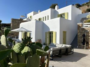 a white house with cacti in front of it at VILLA AGNES MYKONOS in Mýkonos City