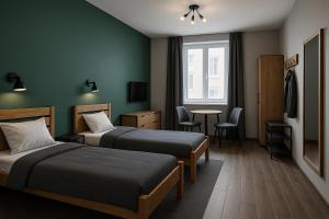 a hotel room with two beds and a table at Pension Bockenem in Bockenem +7 photos