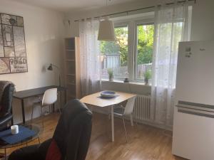 a kitchen and dining room with a table and a window at Fingal 9 studio apartments in Landskrona
