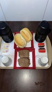 a tray with a plate of food on a table at Hotel rebeka in São Paulo +21 photos