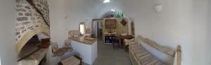 a hallway of a house with a room with a fireplace at Corones House in Frilingiánika