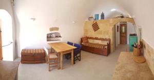 a living room with a table and a play kitchen at Corones House in Frilingiánika +6 photos