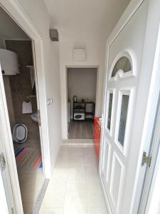 a hallway with a door leading into a room at Studio apartman NN - Boračko jezero in Konjic +15 photos