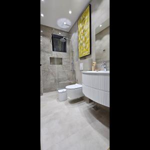 a bathroom with a toilet and a tub and a sink at Bahr DELUX App & Suite in Ulcinj