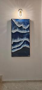 a painting hanging on a wall in a room at Bahr DELUX App & Suite in Ulcinj
