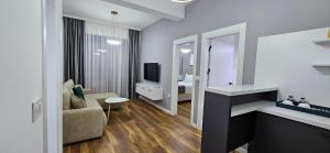 a living room with a couch and a television at Bahr DELUX App & Suite in Ulcinj