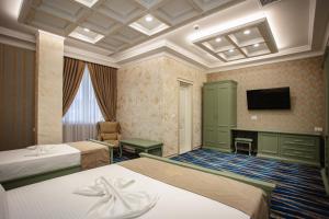 Postel nebo postele na pokoji v ubytování Ervini Boutique Hotel