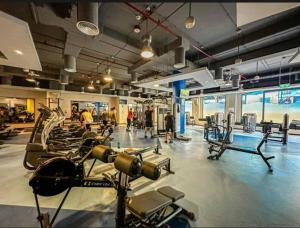 a gym with a bunch of cardio equipment in it at Emirat Premium DxB in Sabkhah